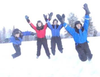 Group of students jumping in the snow