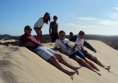 Students lounging on the sand