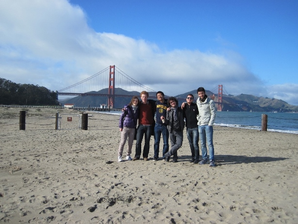 Group on beach in front of bride