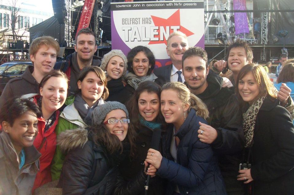 Group in front of sign