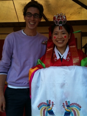 Student and woman in traditional clothing