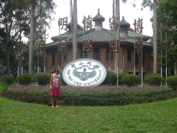 Student in front of university sign