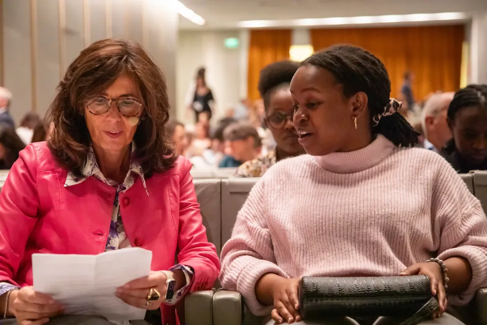 Antonella Carù, Dean for Development and Alumni Relations, talks with a student in the Aula Magna.