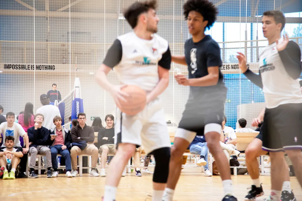 Players passing the ball keeps the viewers' attention high during a basketball match.