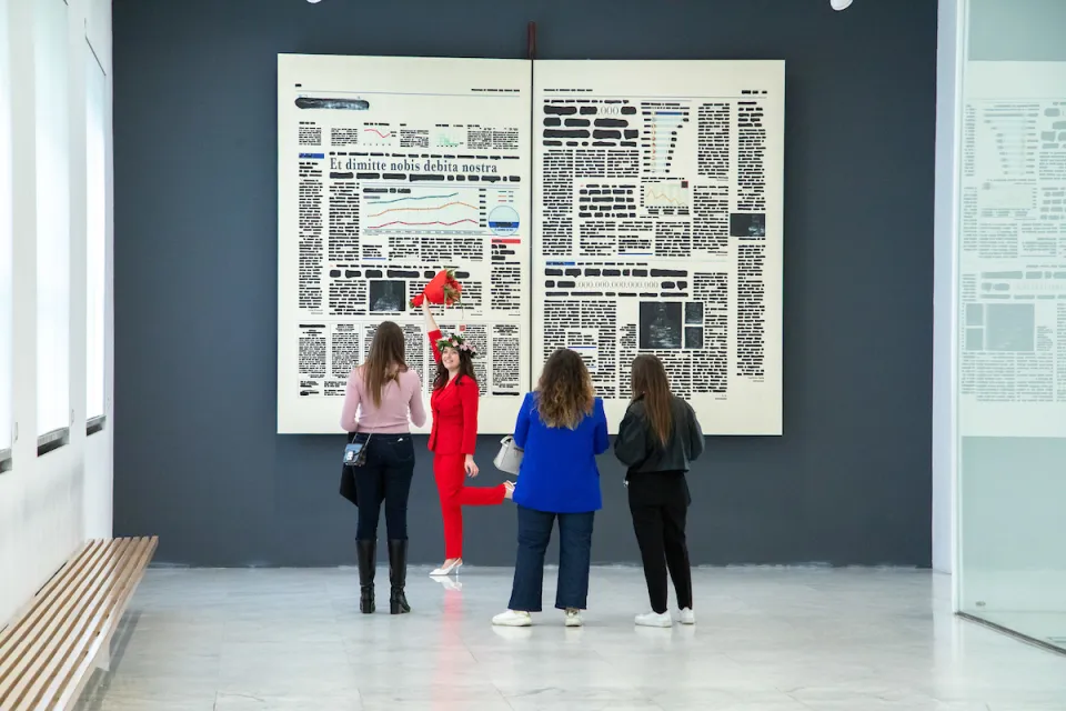 A student poses for her graduation photos in front of one the Bocconi Art Gallery artworks in the Sarfatti 25 building.