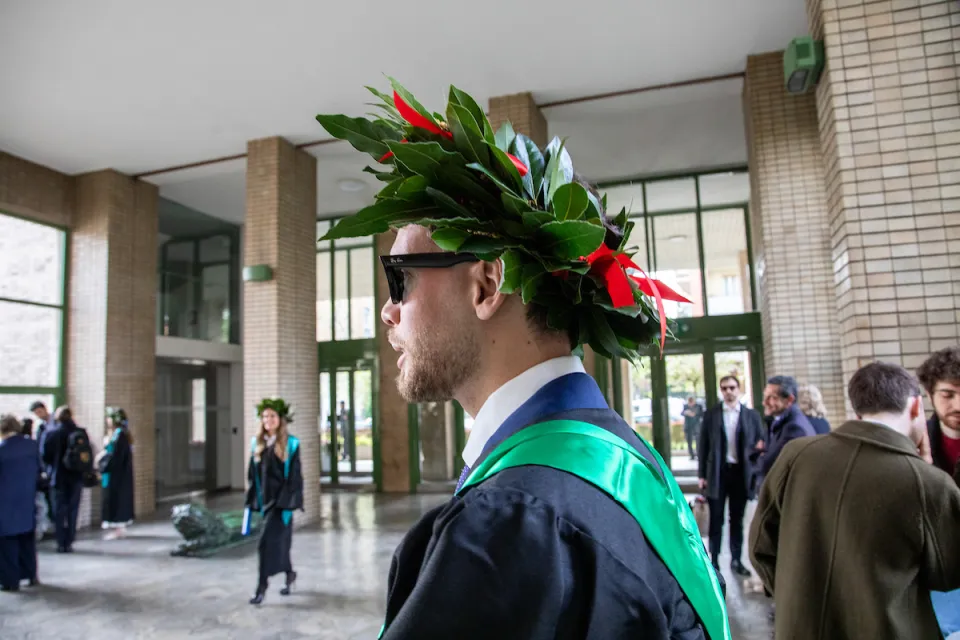 Newly graduated student wearing a laurel crown and sunglasses.