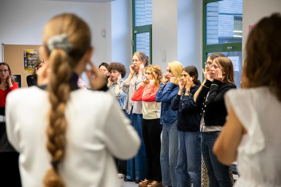 Students warming up their voice to prepare for a music class in the Campus Life spaces.