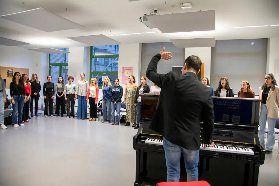 Students warming up their voice to prepare for a music class in the Campus Life spaces.