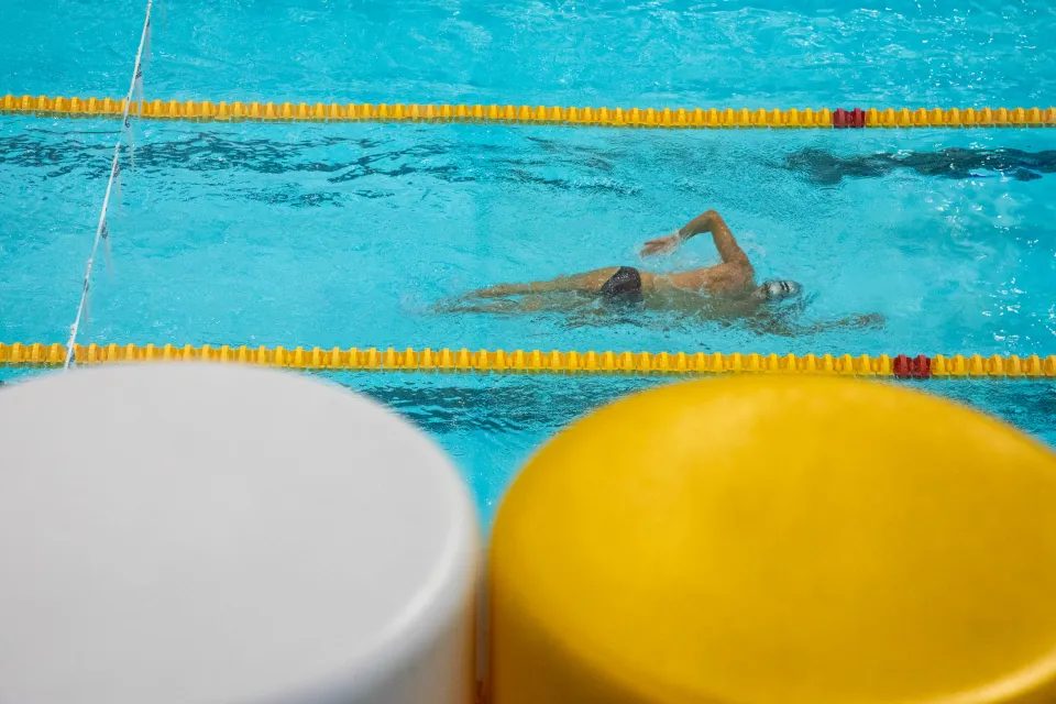 A student swimming in the Bocconi Sport Center pool.