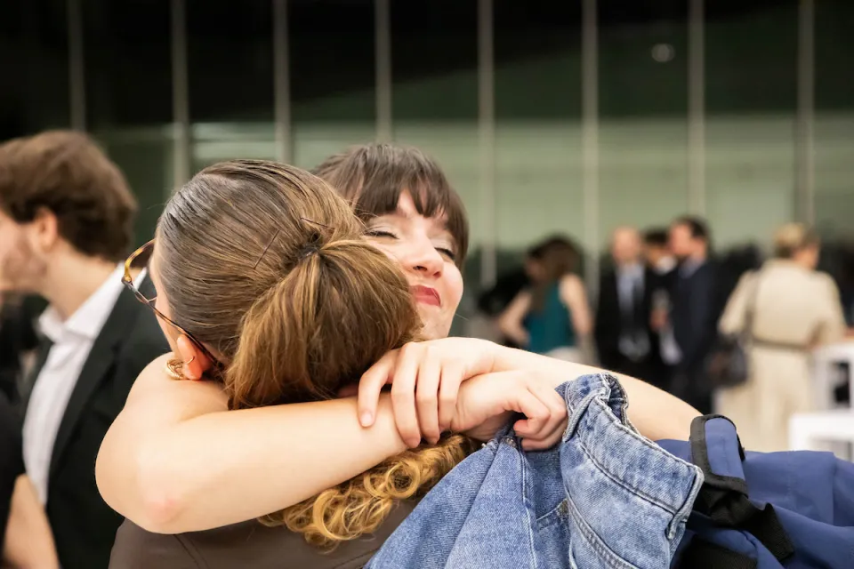 Two women embrace during the Donor Event evening.