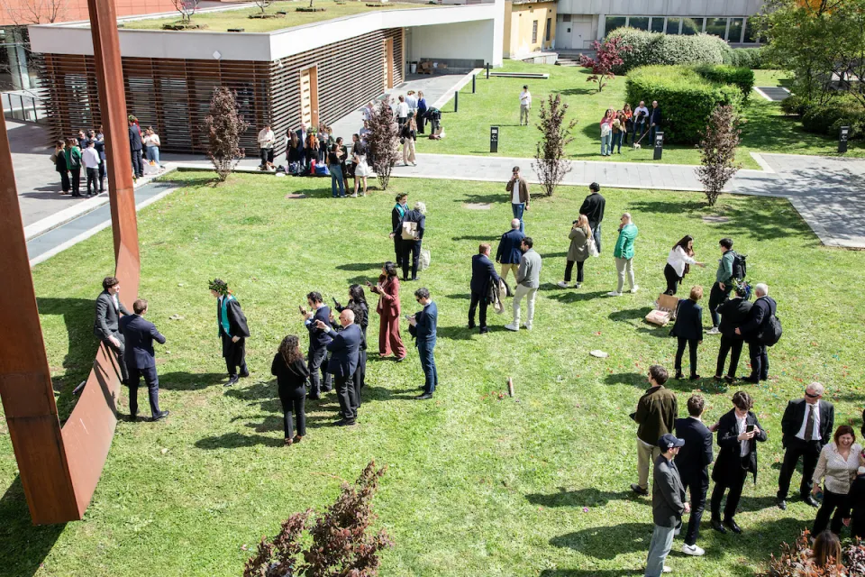 Families and students relaxing after a graduation session, Piazza Sraffa garden.