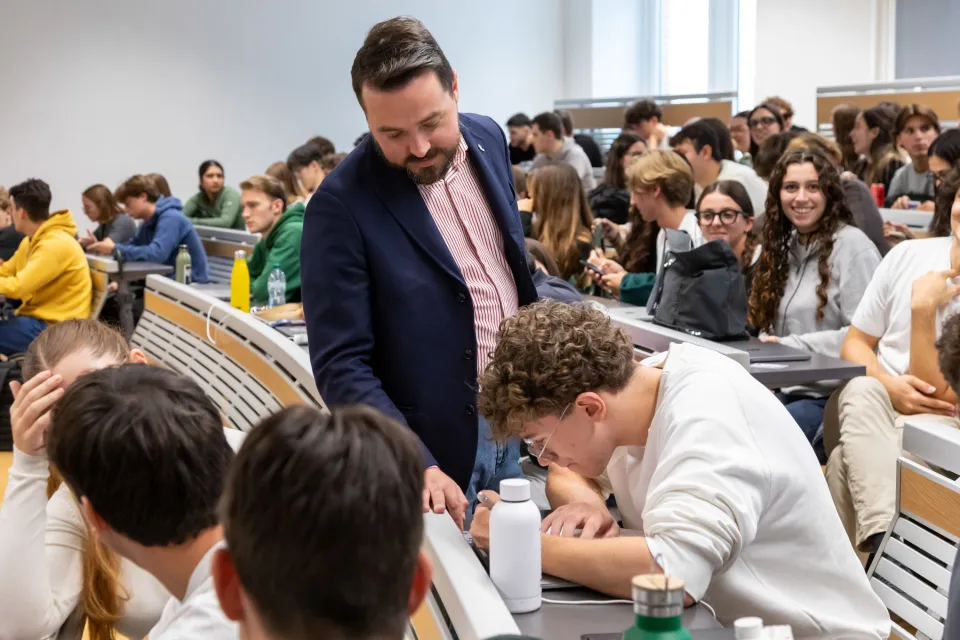 A faculty member engages with a student during a lesson.