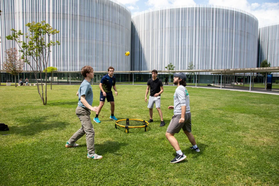 Students playing sports on the lawns of the new Urban Campus.