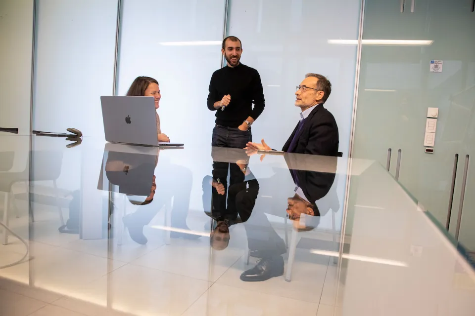 A moment of joyful exchange between three professors.