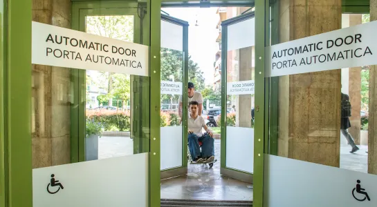 Student using automatic door on Bocconi campus